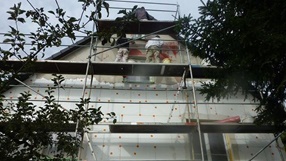 Bild: Stuckateure beim Anbringen der Fassadendämmung
